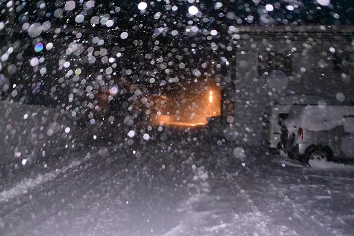 早朝の除雪作業を終えて。降りしきる雪の奥に街灯の明かりを遠くに望んで（２０２６年１月３０日）。